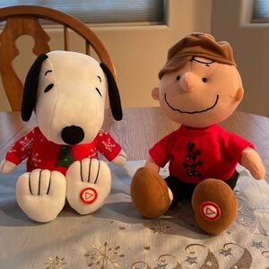 Snoopy and Charlie Brown w/ buttons on their feet to play tunes. Just like new.